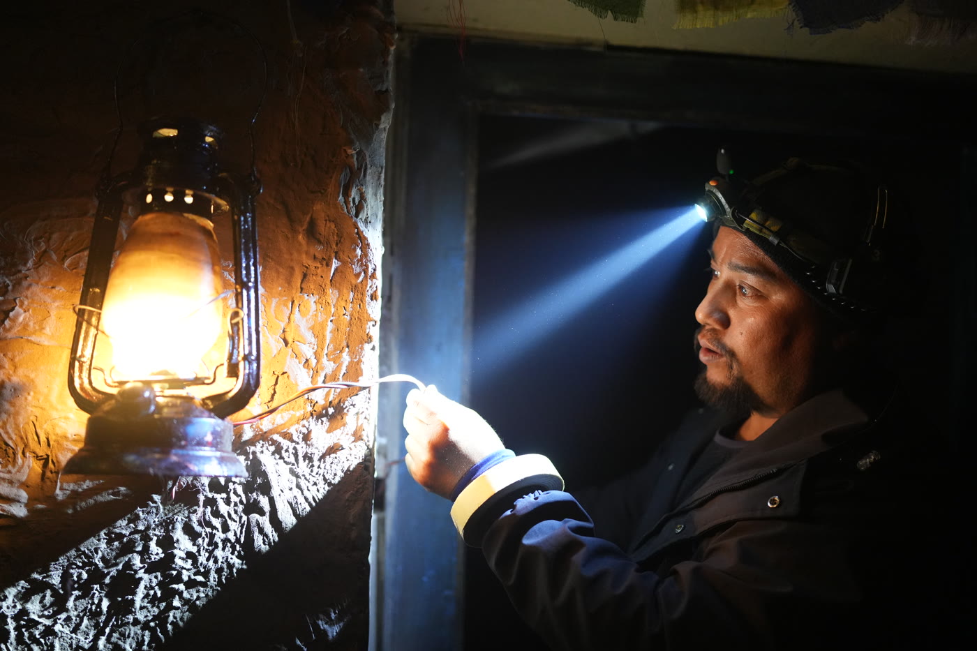 Still from Himalayan Gold: lantern light inside the shelter